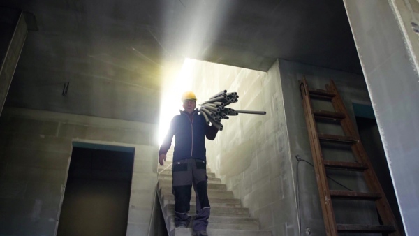 Accident of a male worker at the construction site. A man falling down from the stairs. Slow motion.