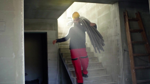 Accident of a male worker at the construction site. A man falling down from the stairs. Slow motion.