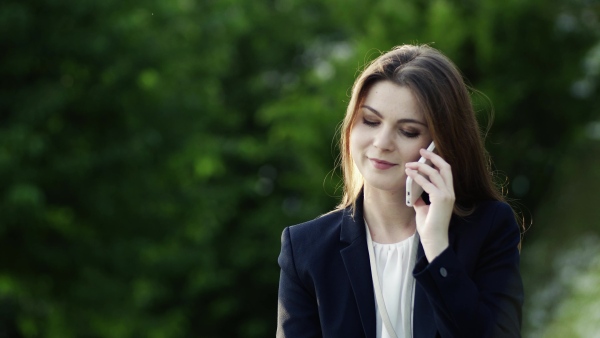 Handsome mature man making a phone call after a car accident, smoke in the background.