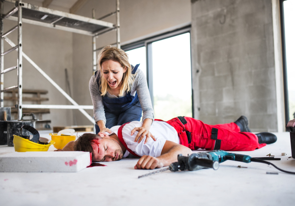 Accident of a male worker at the construction site. A woman found man worker lying unconscious on the floor, screaming.