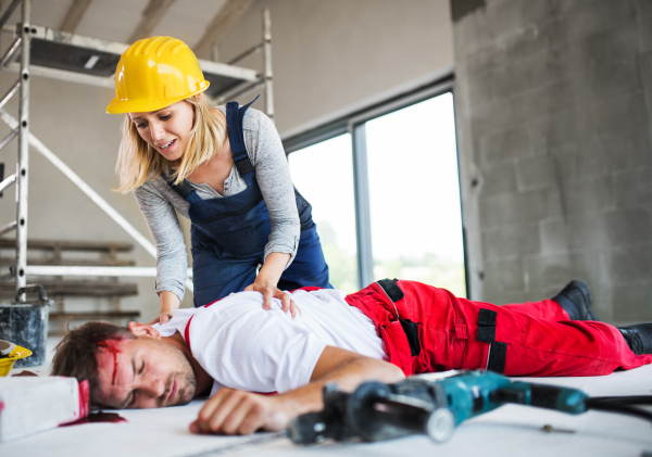 Accident of a male worker at the construction site. A woman found man worker lying unconscious on the floor.