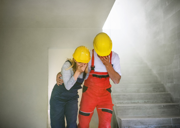 Woman and man workers running at the construction site, suffocating. Carbon monoxide poisonous gas cloud.