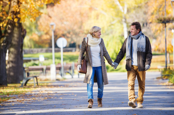 Beautiful active seniors on a walk in a town park