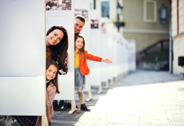 A happy family with children having fun in town in autumn, family time.