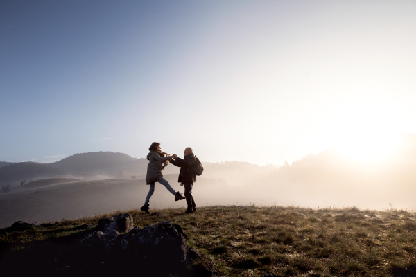 Active senior couple on a walk in a beautiful autumn nature.