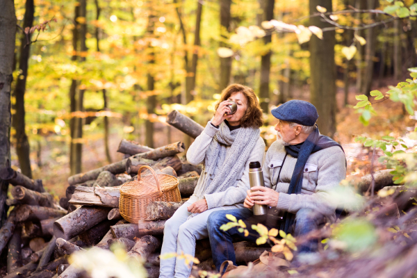 Active senior couple on a walk in a beautiful autumn nature.