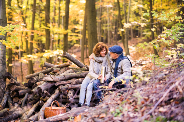 Active senior couple on a walk in a beautiful autumn nature.