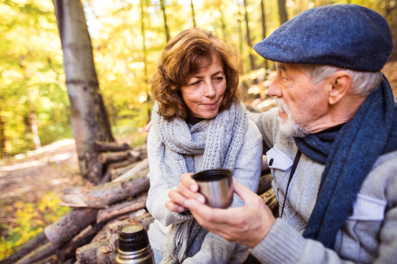 Active senior couple on a walk in a beautiful autumn nature.