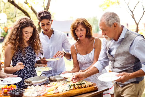 Family celebration outside in the backyard. Big garden party.