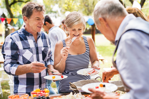 Family celebration outside in the backyard. Big garden party.