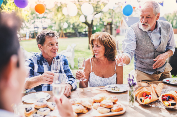 Family celebration outside in the backyard. Big garden party.