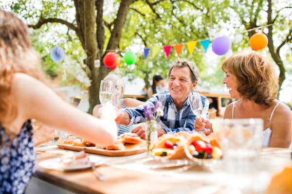 Family celebration outside in the backyard. Big garden party.