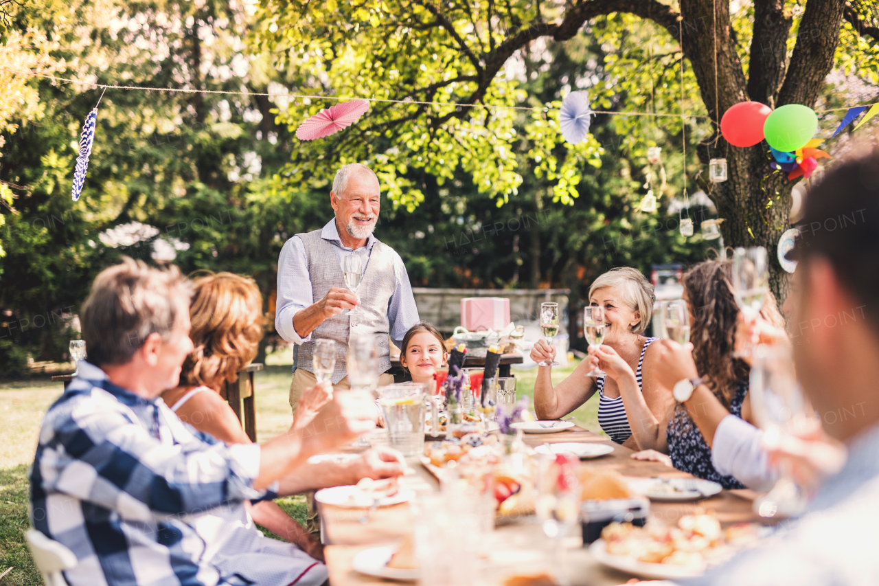 Family celebration outside in the backyard. Big garden party.