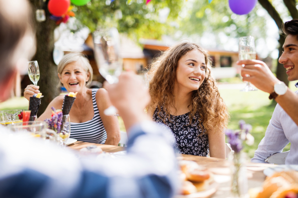 Family celebration outside in the backyard. Big garden party.