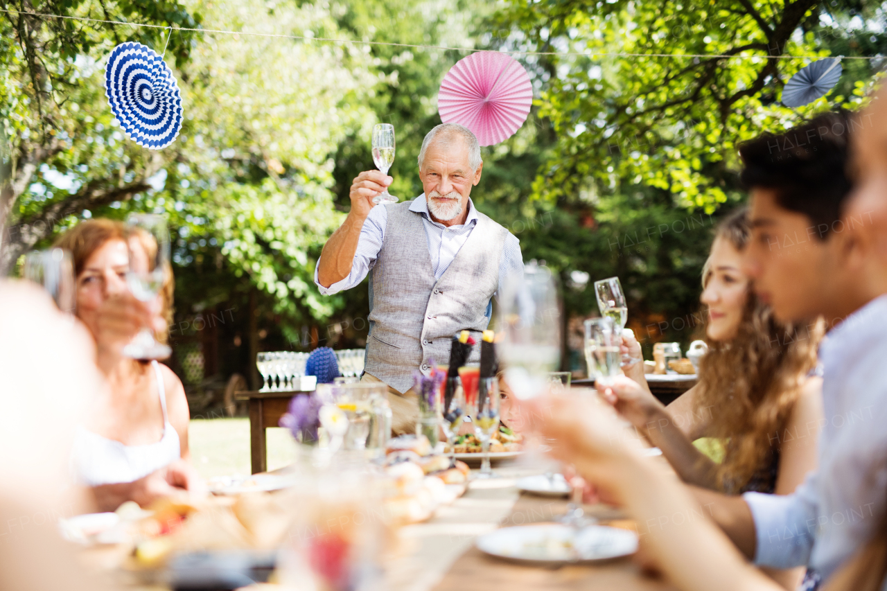 Family celebration outside in the backyard. Big garden party.