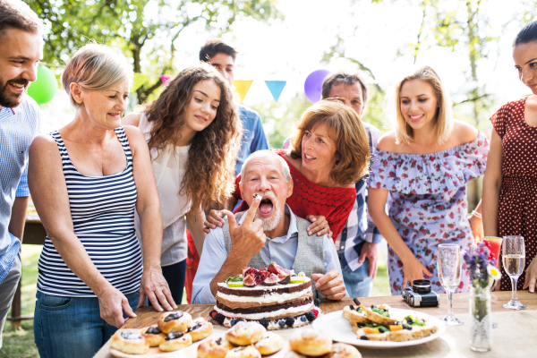 Family celebration outside in the backyard. Big garden party. Birthday party.