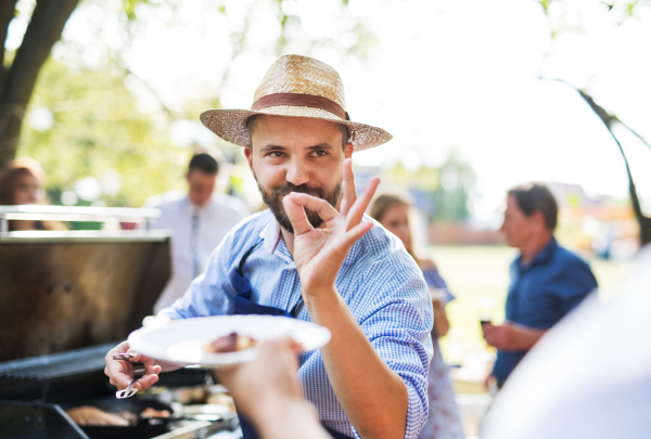 Family celebration outside in the backyard. Barbecue party.