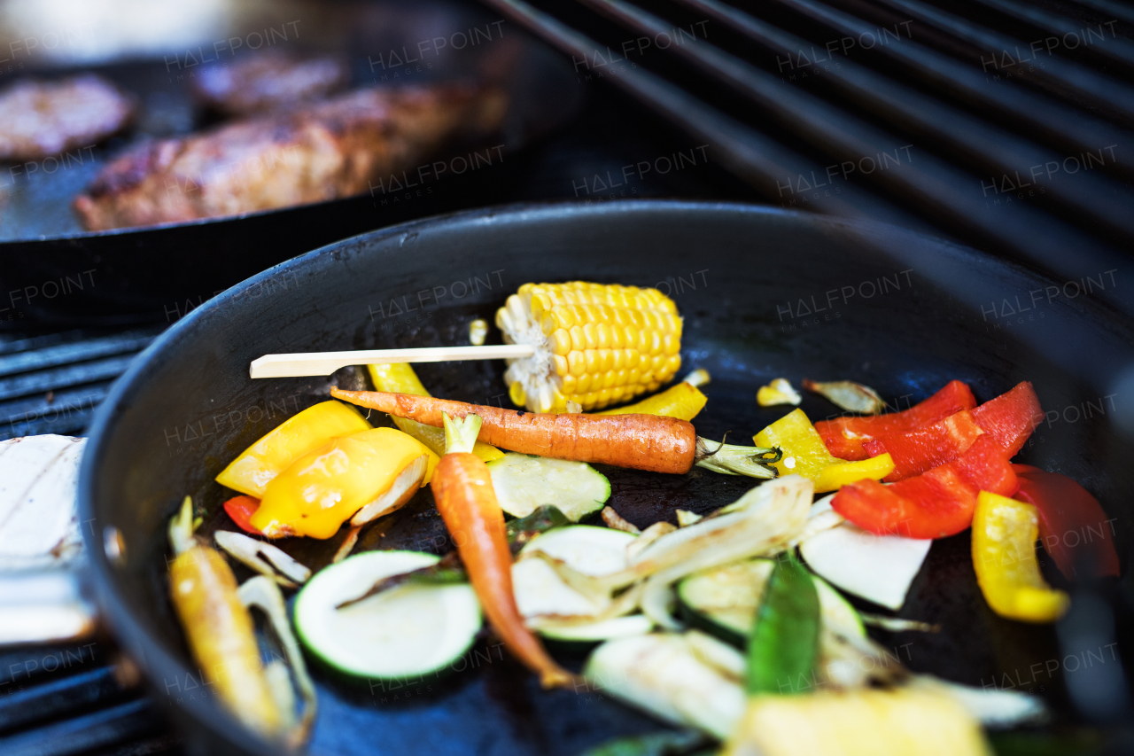 Vegetables on the grill. Family celebration outside in the backyard. Big garden party.