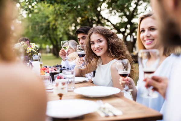 Family celebration outside in the backyard. Big garden party.