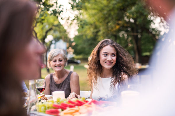 Family celebration outside in the backyard. Big garden party.