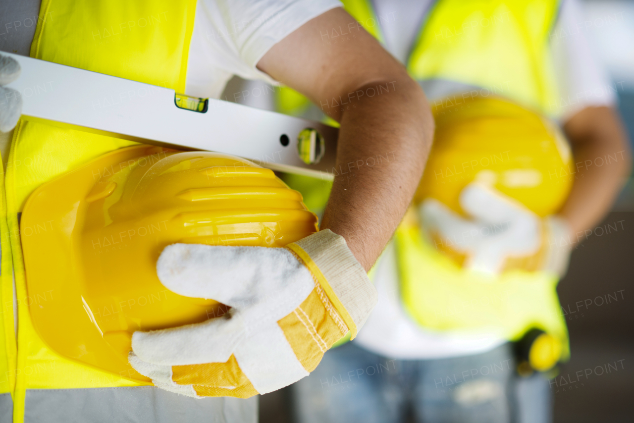 Two builders working on building.