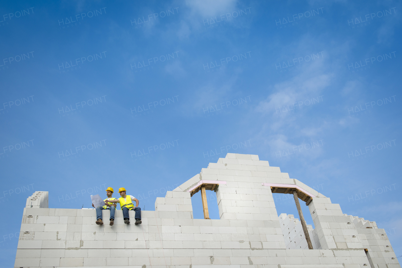 Two builders working on building.