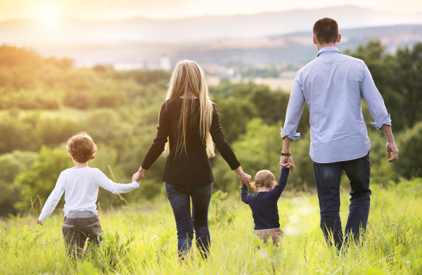 Young beautiful family spending time together in the nature, having fun.