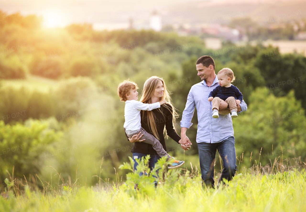 Young beautiful family spending time together in the nature, having fun.