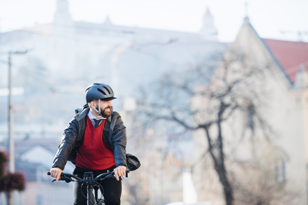 Hipster businessman commuter with bicycle traveling to work in city. Copy space.