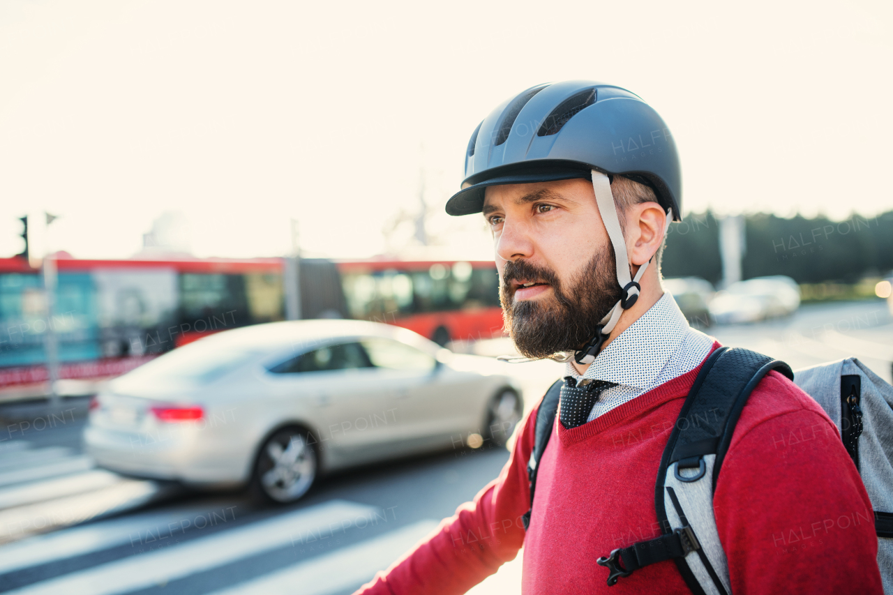 Hipster businessman commuter with bicycle traveling to work in city. Copy space.