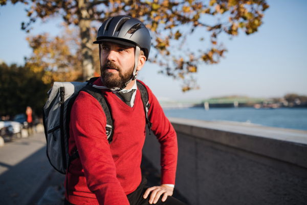 Hipster businessman commuter with bicycle traveling to work in city. Copy space.