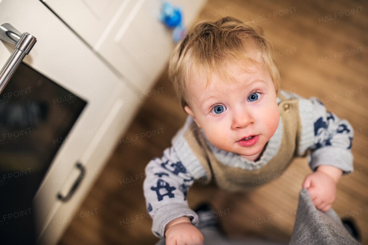 Top view of a cute toddler boy looking up at home. Close up.