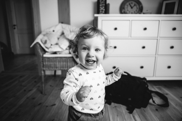 Cute little boy at home in his bedroom smiling.