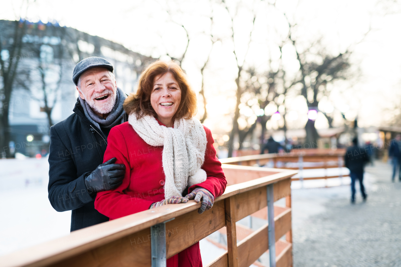 Happy senior couple on a walk in a city in winter.