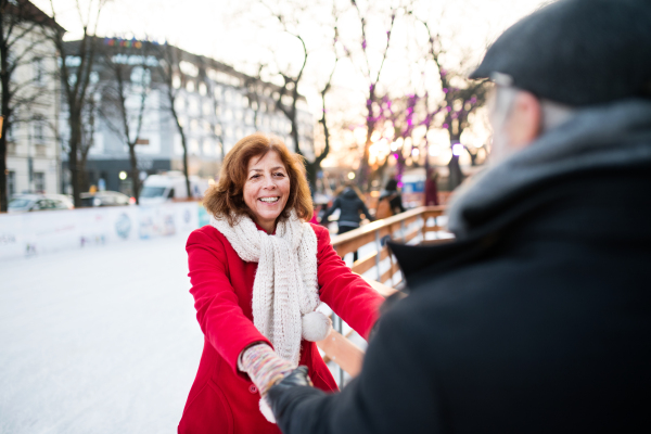 Happy senior couple on a walk in a city in winter.