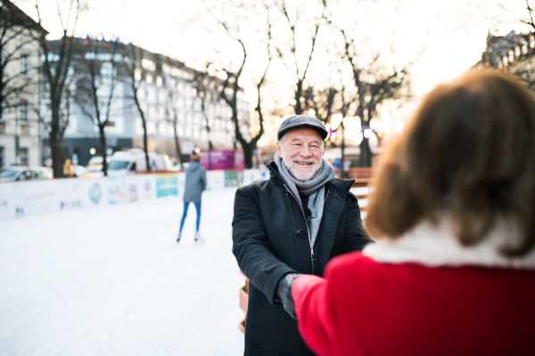 Happy senior couple on a walk in a city in winter.