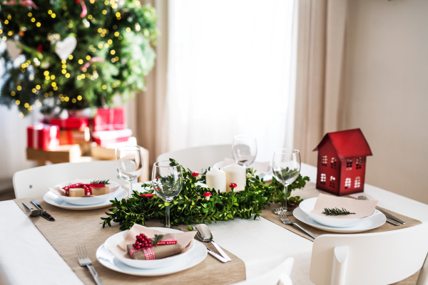 A table set for a dinner for four people at home at Christmas time.