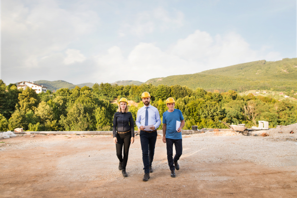 Architect, civil engineer and home owner at the construction site.