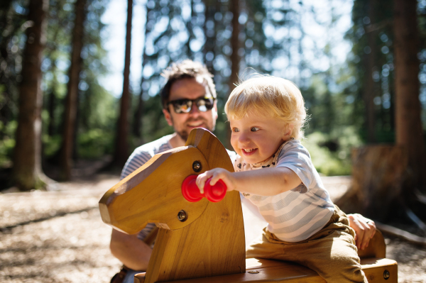 Young father with cute little boy on the playground.