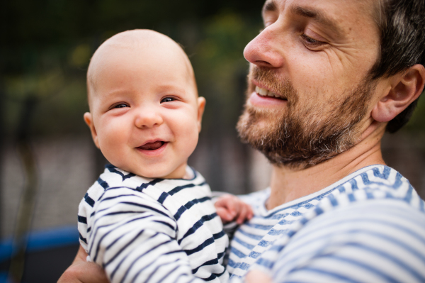 Father with happy little baby, summer day.