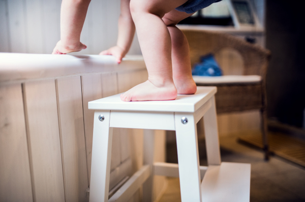 Unrecognizable little toddler boy getting into a bathtub. Domestic accident. Dangerous situation in the bathroom.