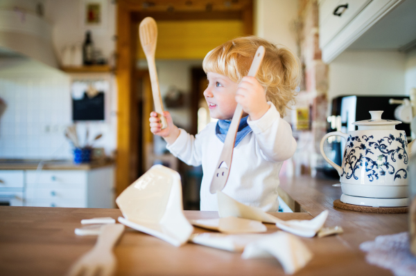 Toddler boy in a dangerous situation at home. Domestic accident. Child safety concept.