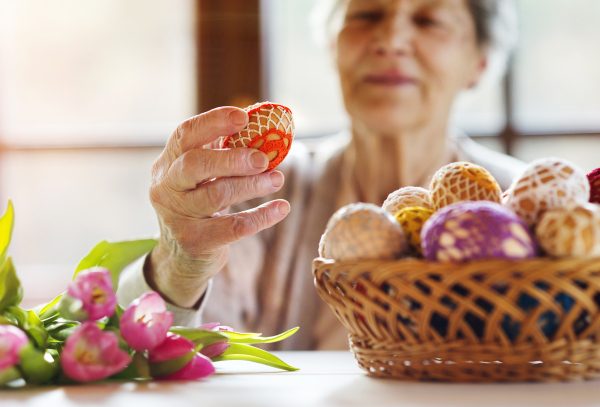 Senior woman doing easter decorations.