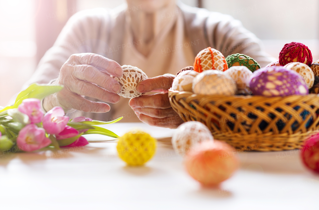 Senior woman doing easter decorations.