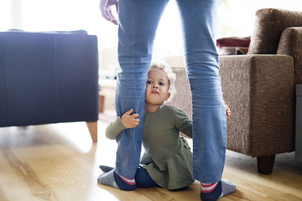 Little girl with father at home playing together.