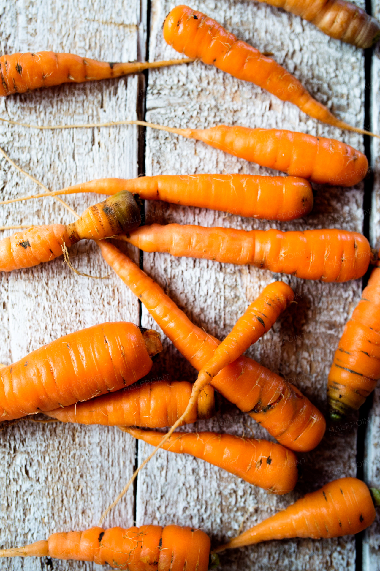 Fresh carrot vegetable laid on white wooden table background. Flat lay.