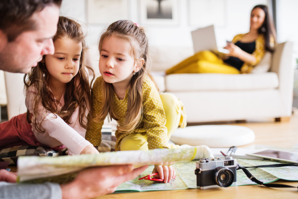 Portrait of a young happy family with two children preparing for holiday at home.