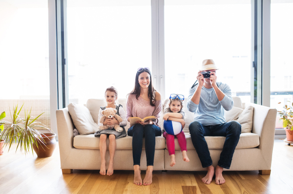 Portrait of a young happy family with two children getting ready for holiday at home.