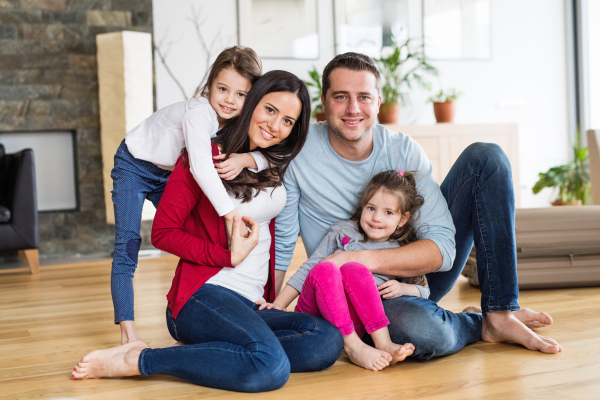 Portrait of a young happy family with two children at home.