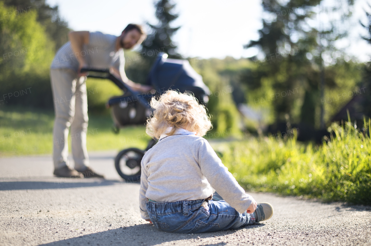 Young father with his son ouside on walk.